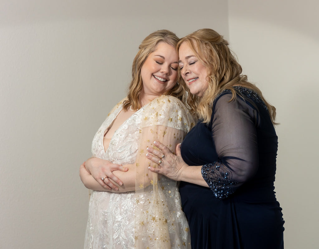 mom and daughter on wedding day with bride wearing mom's jewelry