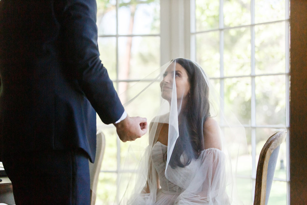 drop sheer barely there wedding veil blusher lifted over bride