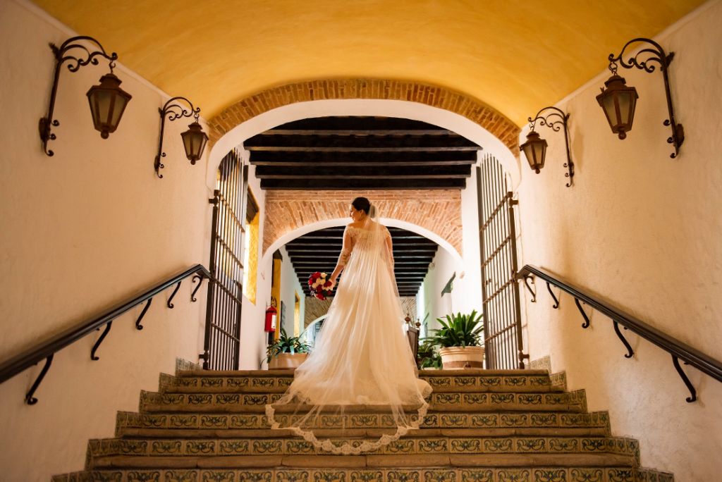 spanish hacienda wedding with bride in long wedding veil on staircase