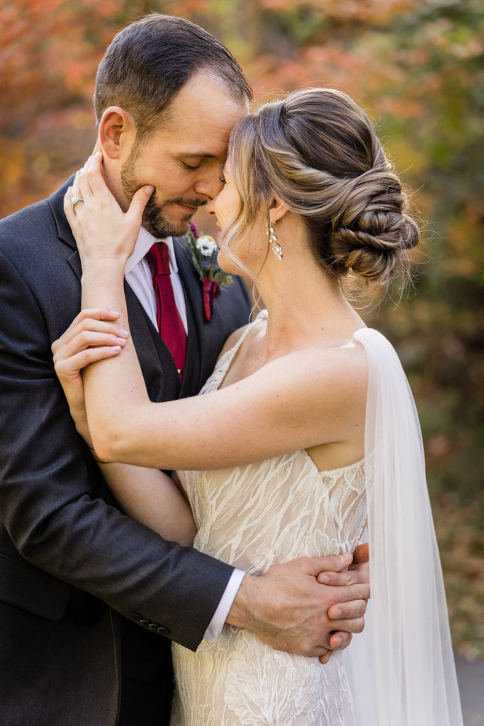 romantic fall wedding with bridal updo and wedding cape veil wings pinned on spaghetti strap dress
