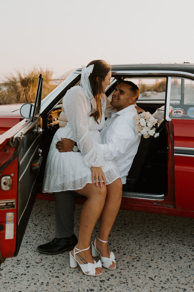 pearl hair bow for retro themed engagement shoot with red classic car