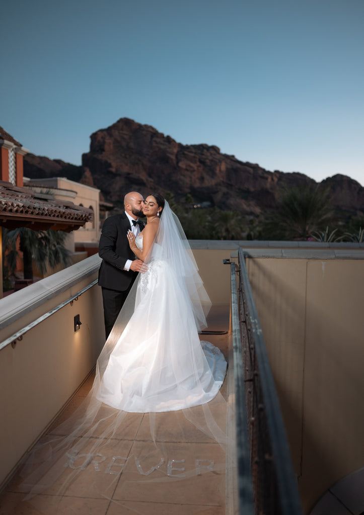 arizona resort wedding with long dramatic white wedding veil with forever embroidered in sparkly letters at bototm
