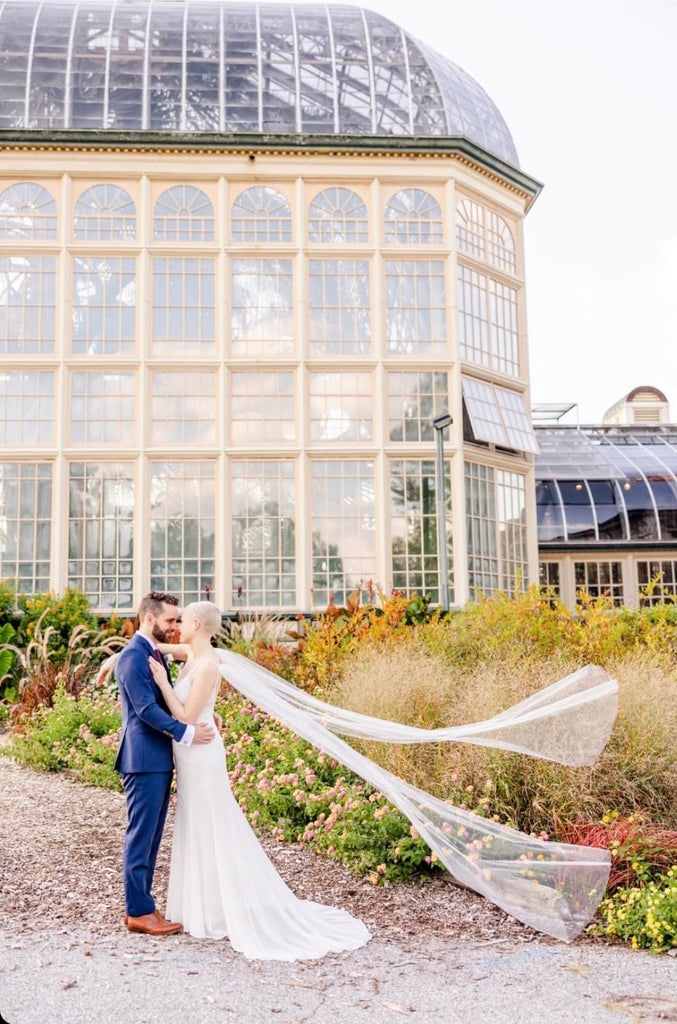 greenhouse wedding ceremony with short hair bride wearing should veil wings