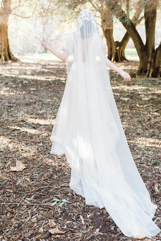 beaded long floor length Juliet cap veil on bride in tree grove