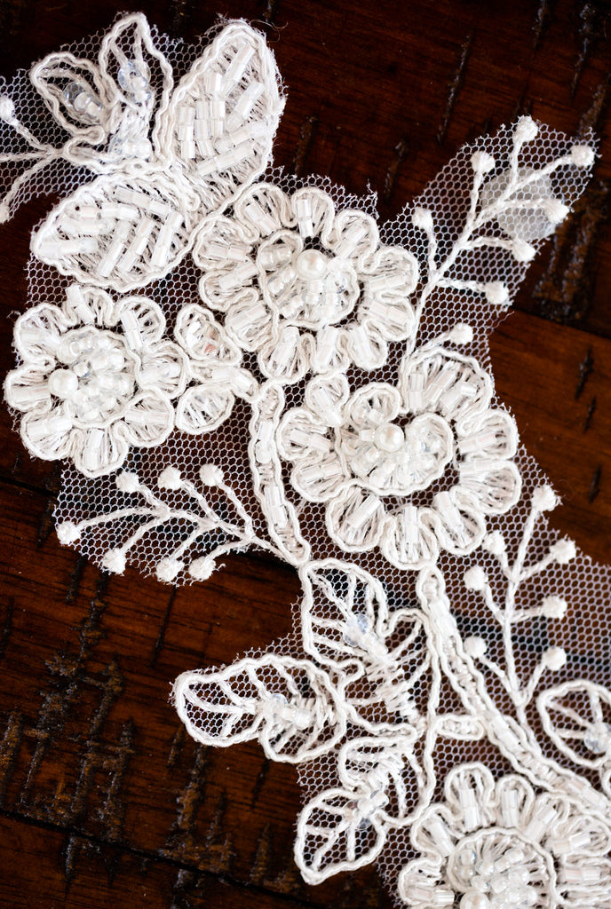 beaded French lace applique for wedding veils with clear and pearl beading on wood background