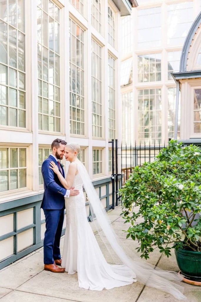 bride without hair wearing bridal crown and long tulle wedding wings