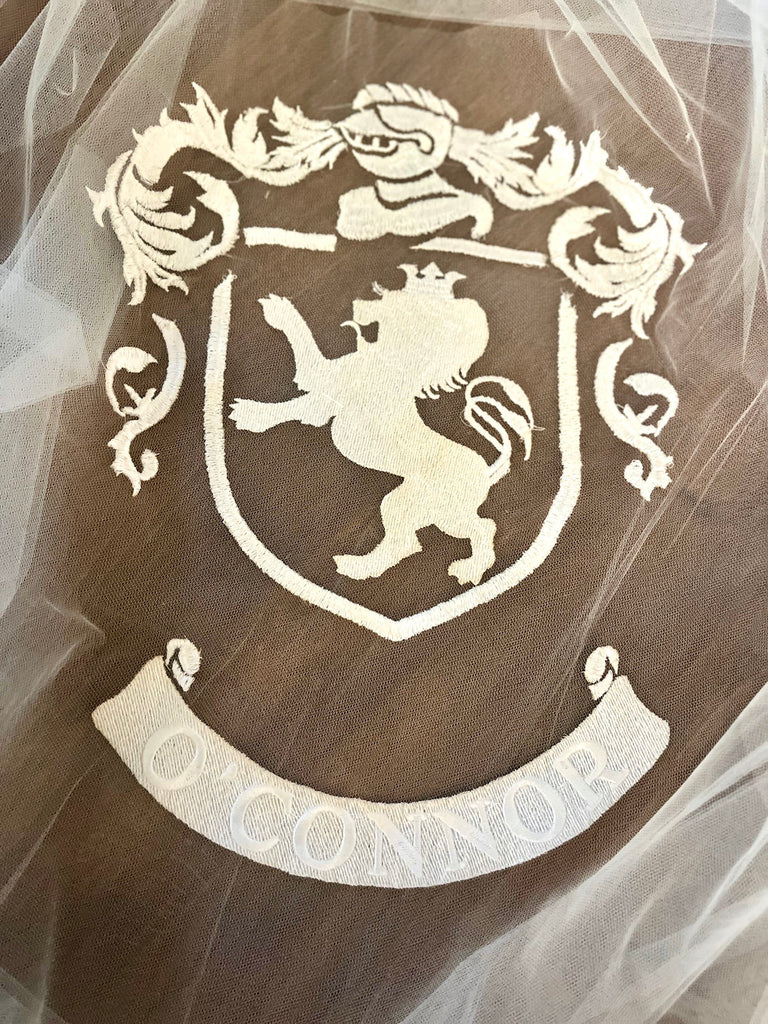 lion wedding crest coat of arms embroidered on a long cathedral veil in ivory