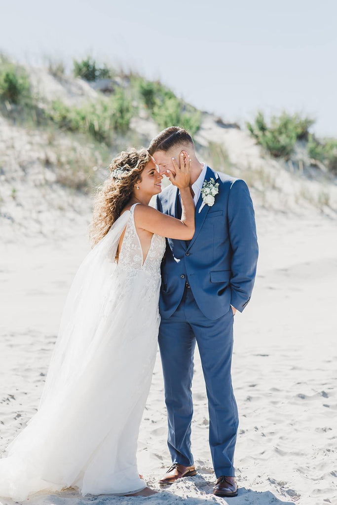 windy beach wedding with bride in long tulle bridal sleeve cape as a veil alternative