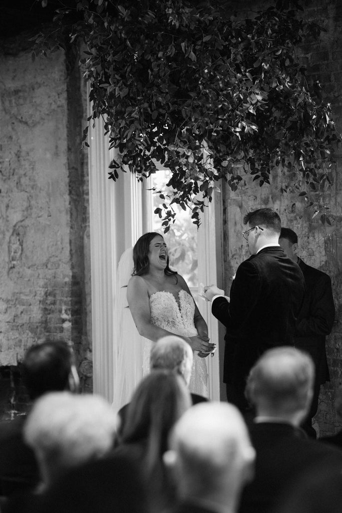 beautiful bride laughing with fiance wearing long two layer puffy wedding veil