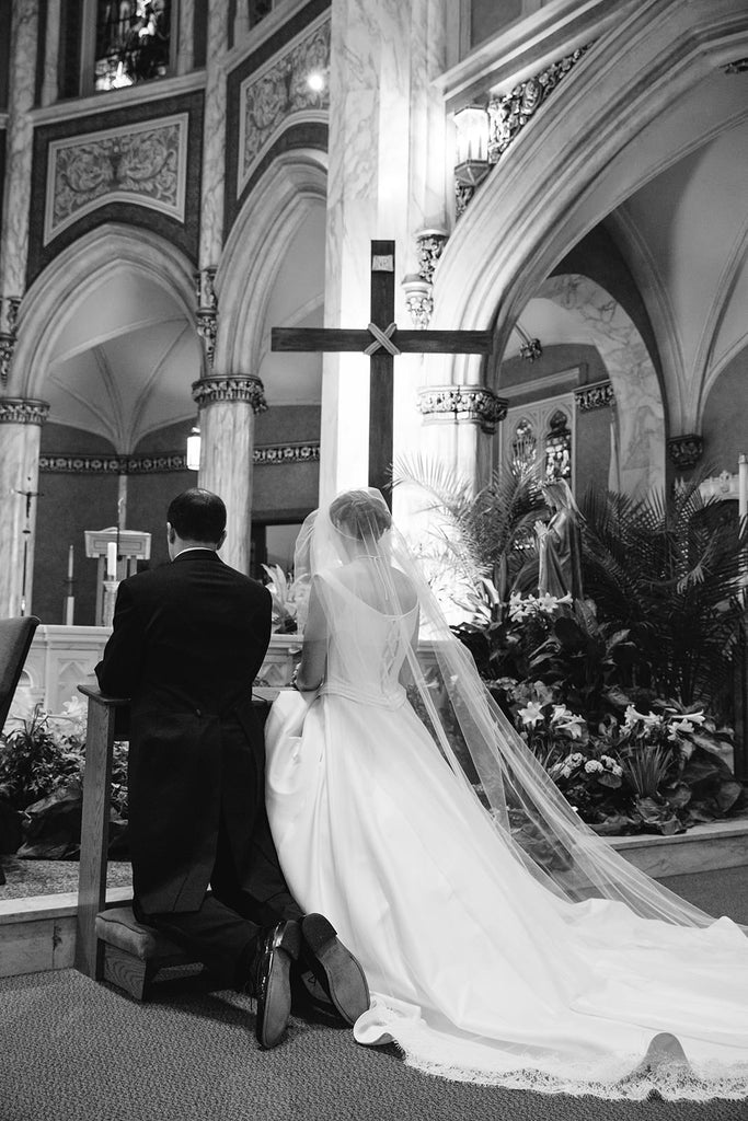classic cathedral wedding in church with bride wearing extra long French alencon lace trimmed cathedral veil
