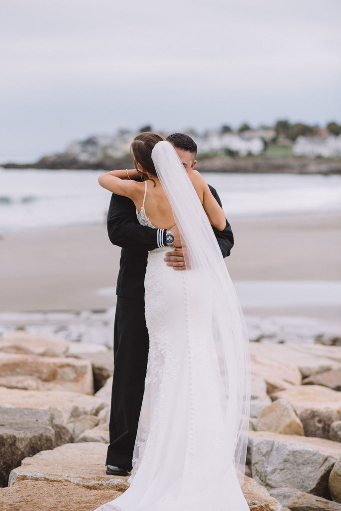 low back spaghetti strap wedding dress accessorized with cut edge wedding veil