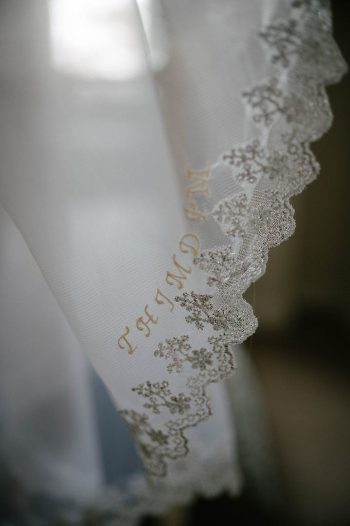 silver embroidered lace trim edge with cursive stitched initials to honor grandmother