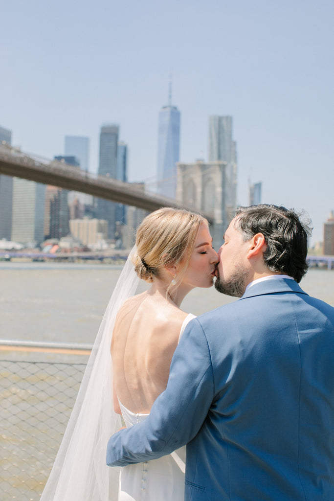 minimalist bride wearing simple wedding veil in front of Brooklyn bridge