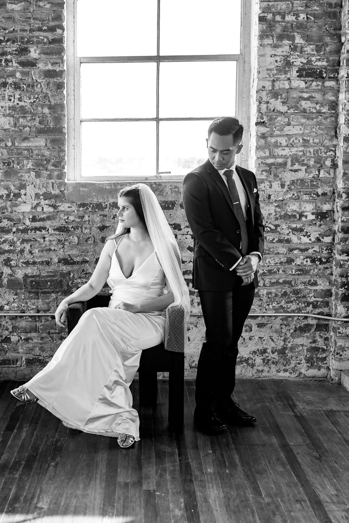 minimalist industrial wedding venue with bride in silk and a fingertip length swiss dot textured bridal veil