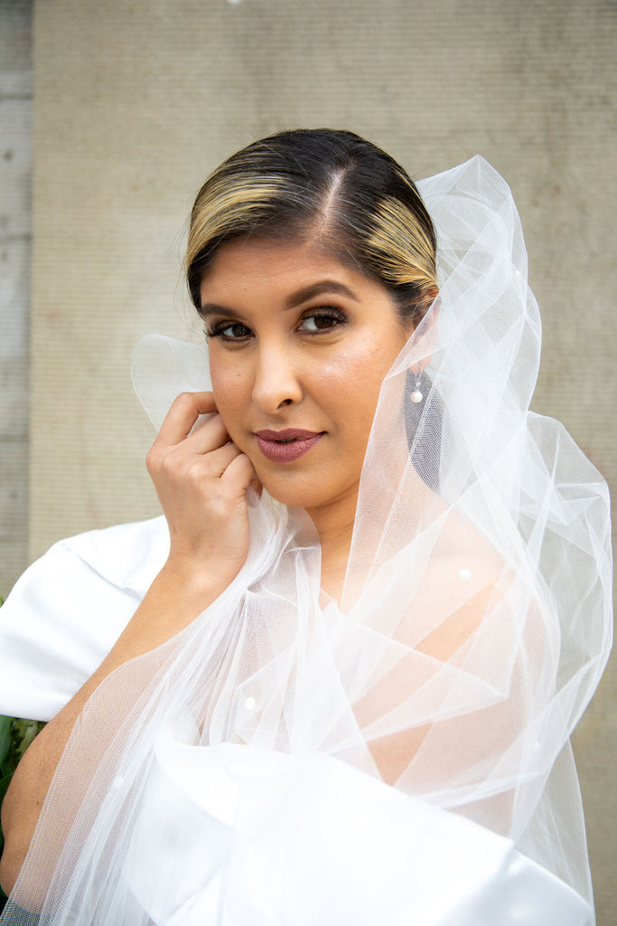 elegant bridal ponytail with pearl cathedral wedding veil