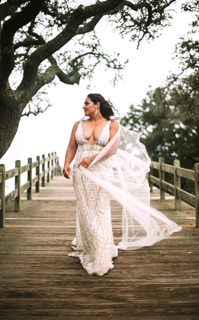 tulle bridal cape with small shoulder bows for plunging V bridal dress