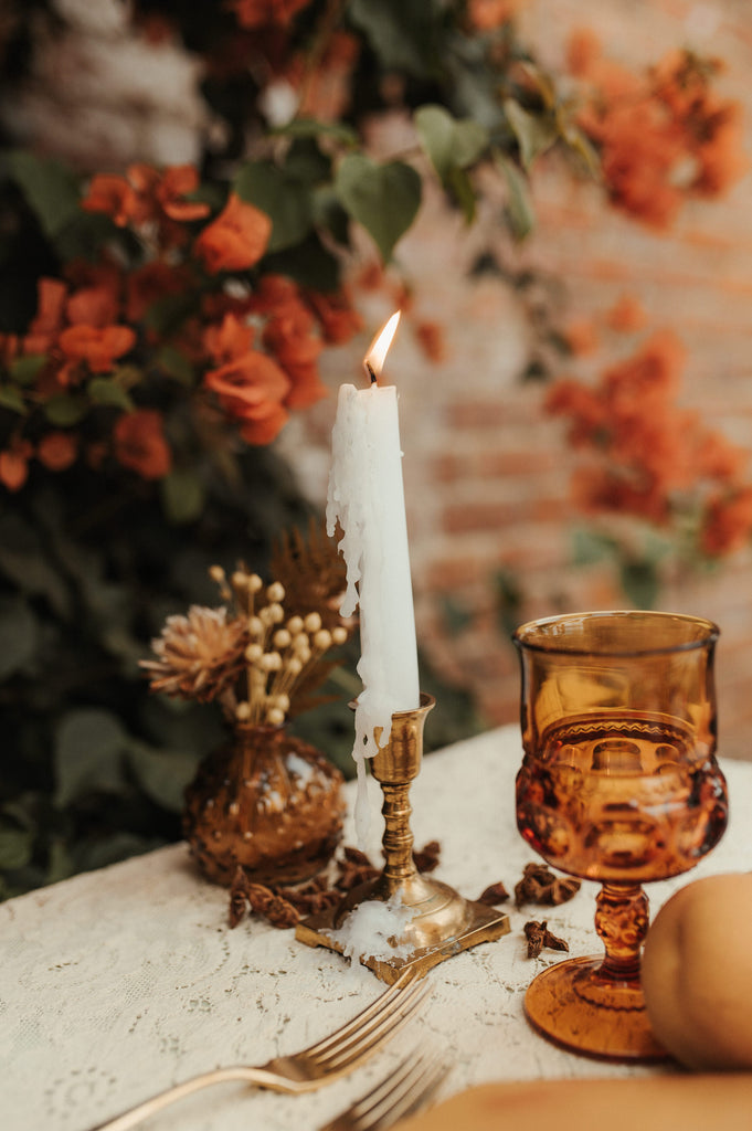 romantic sweethearts table at wedding reception with candles and rust goblets for rustic warm decor