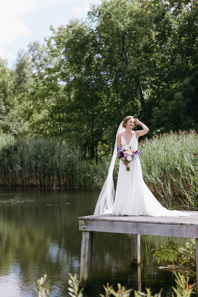 ethereal narrow 54 inch width long cathedral veil on bride at pier overlooking lake