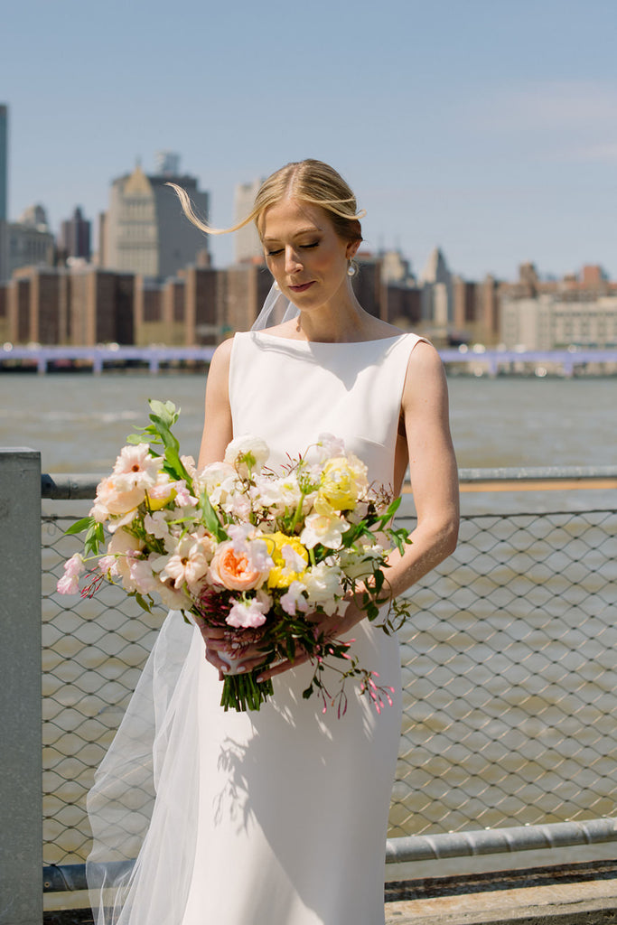 New Jersey wedding with bride wearing silk off white veil and holding yellow and pink bouquet