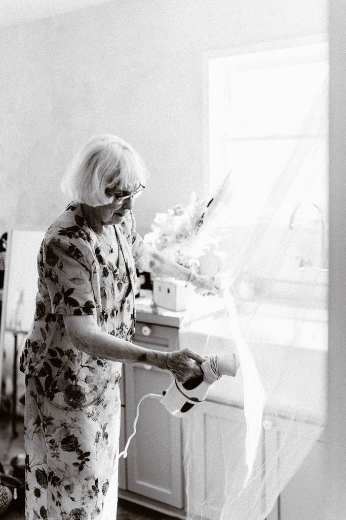 grandma of the bride steaming tulle wedding veil for granddaughter