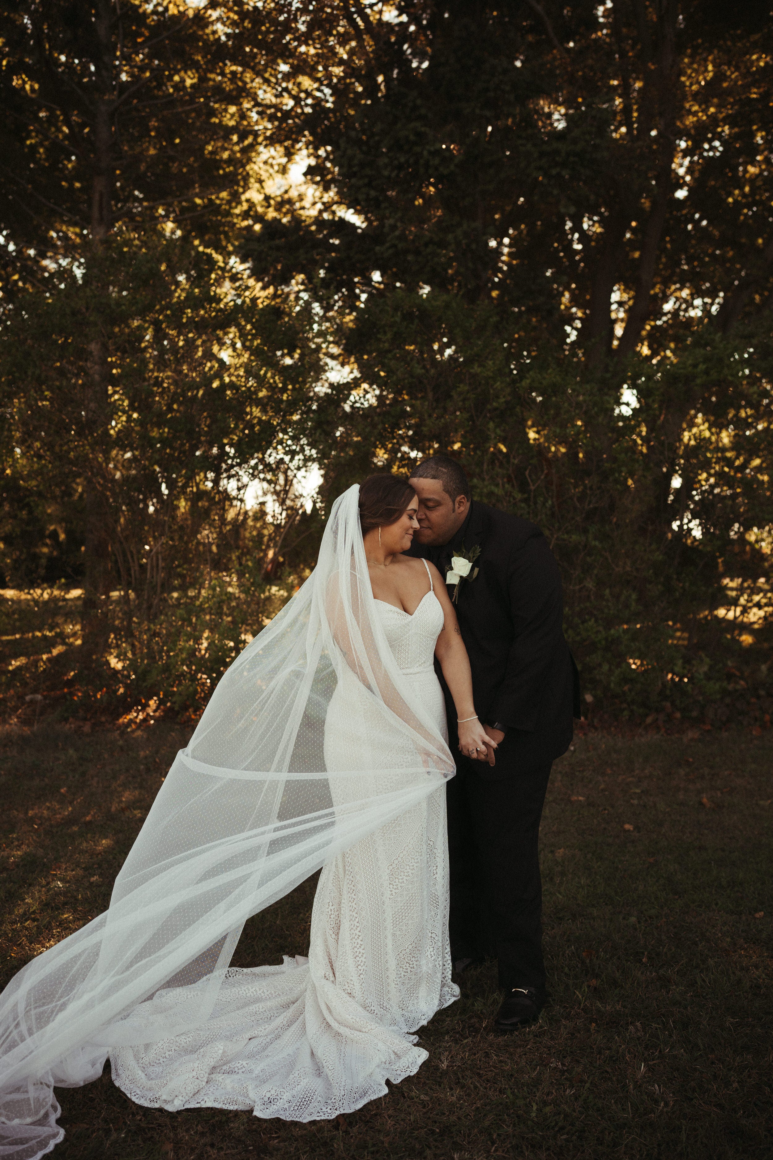 playful ivory Swiss dot wedding veil with lace trim and elegant curvy bride