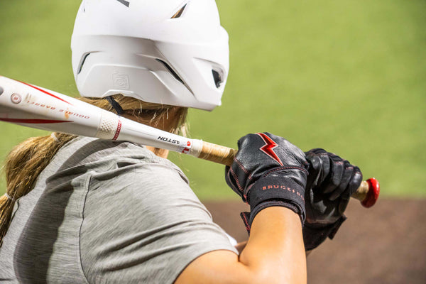 Softball player ready to swing bat.