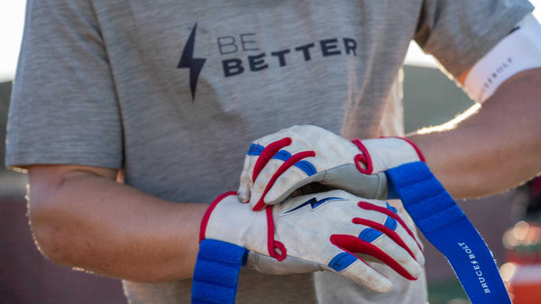 BRUCE BOLT athlete straps on his batting gloves before heading to the plate.