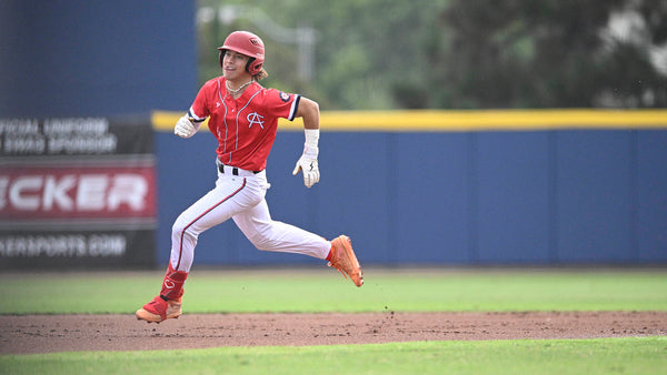 Bruce Bolt athlete rounding second base.