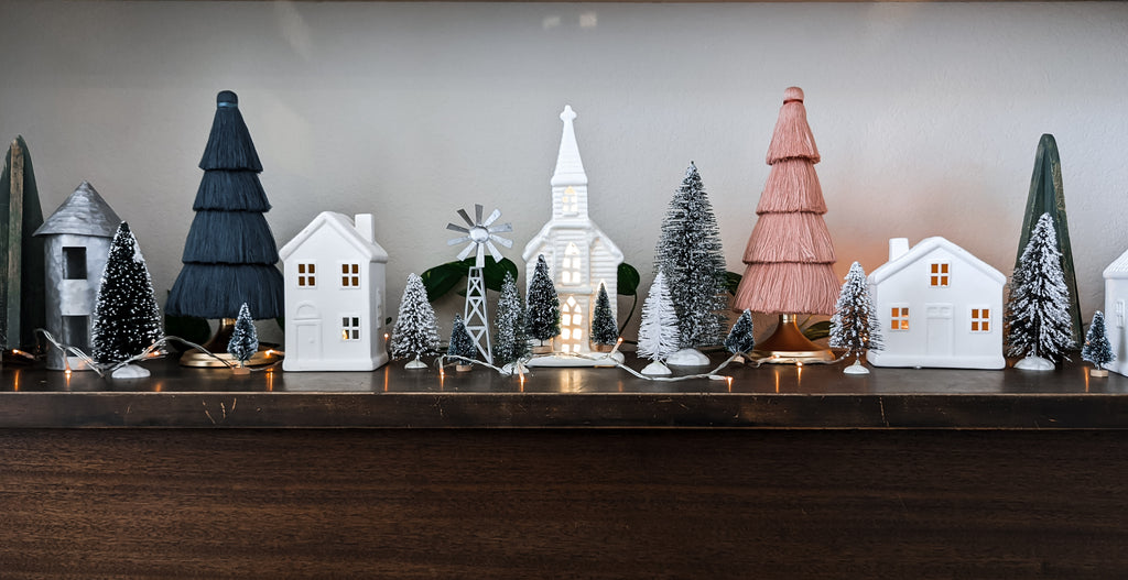 christmas village with trees and houses, family holiday traditions to start with kids