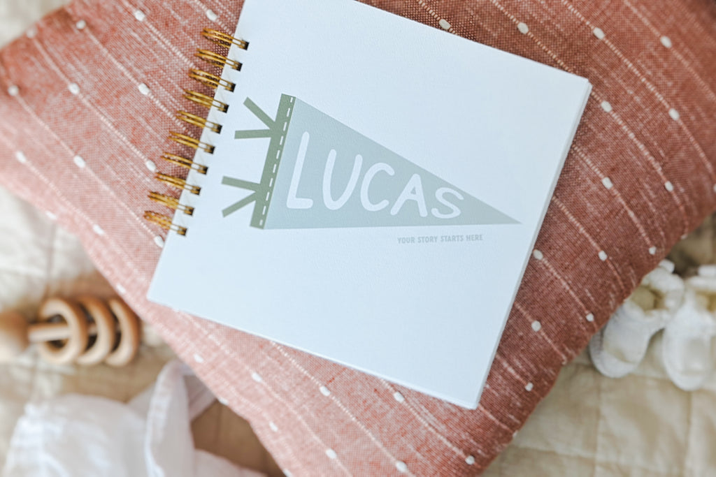 baby name lucas, baby book on bed, top baby names, baby name trends, top boy names 2023, top girl names 2023, baby name trends 2023