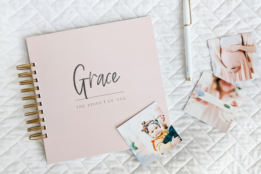girl baby name grace, girl baby book on bed, top baby names, baby name trends, top boy names 2023, top girl names 2023, baby name trends 2023