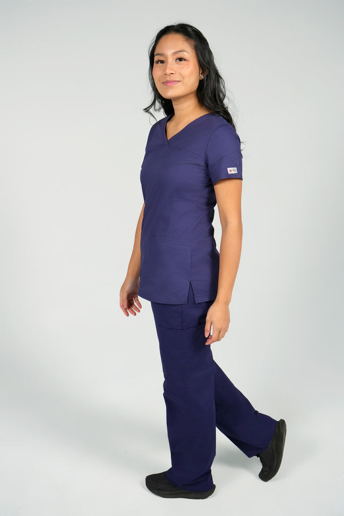 Nursing student wearing women's navy scrub top and scrub pants