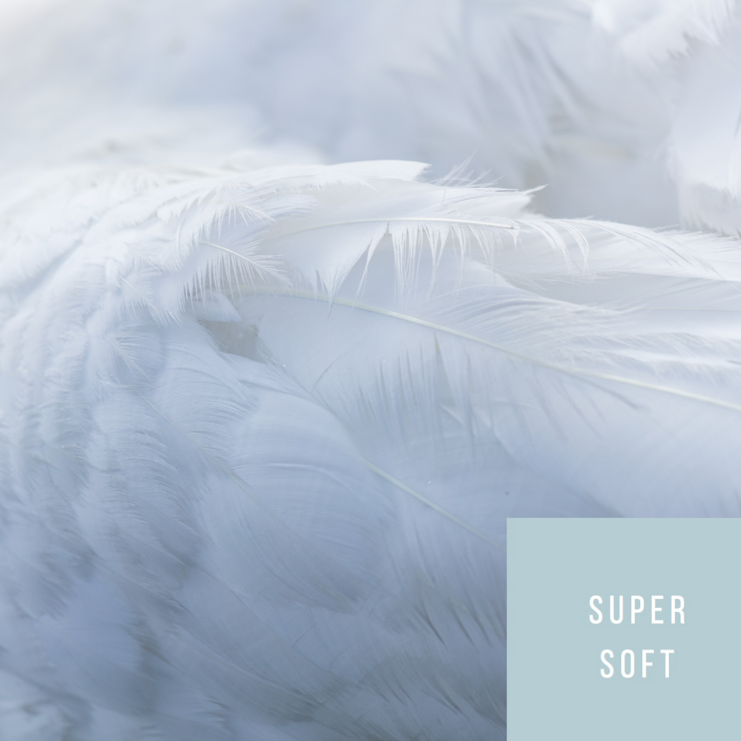 Pile of feathers demonstrating the super soft feel of Rhino scrubs that are gentle on the skin and comfortable to wear