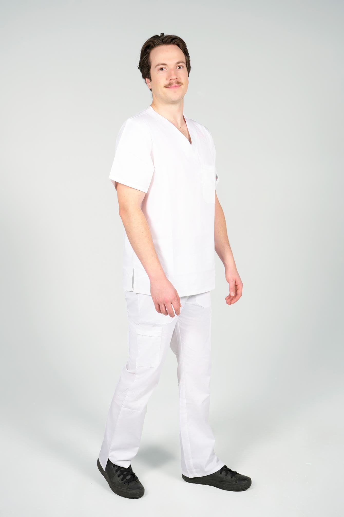 Male nurse wearing white scrub top and bottom