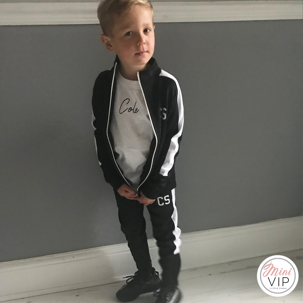 black tracksuit with white stripe