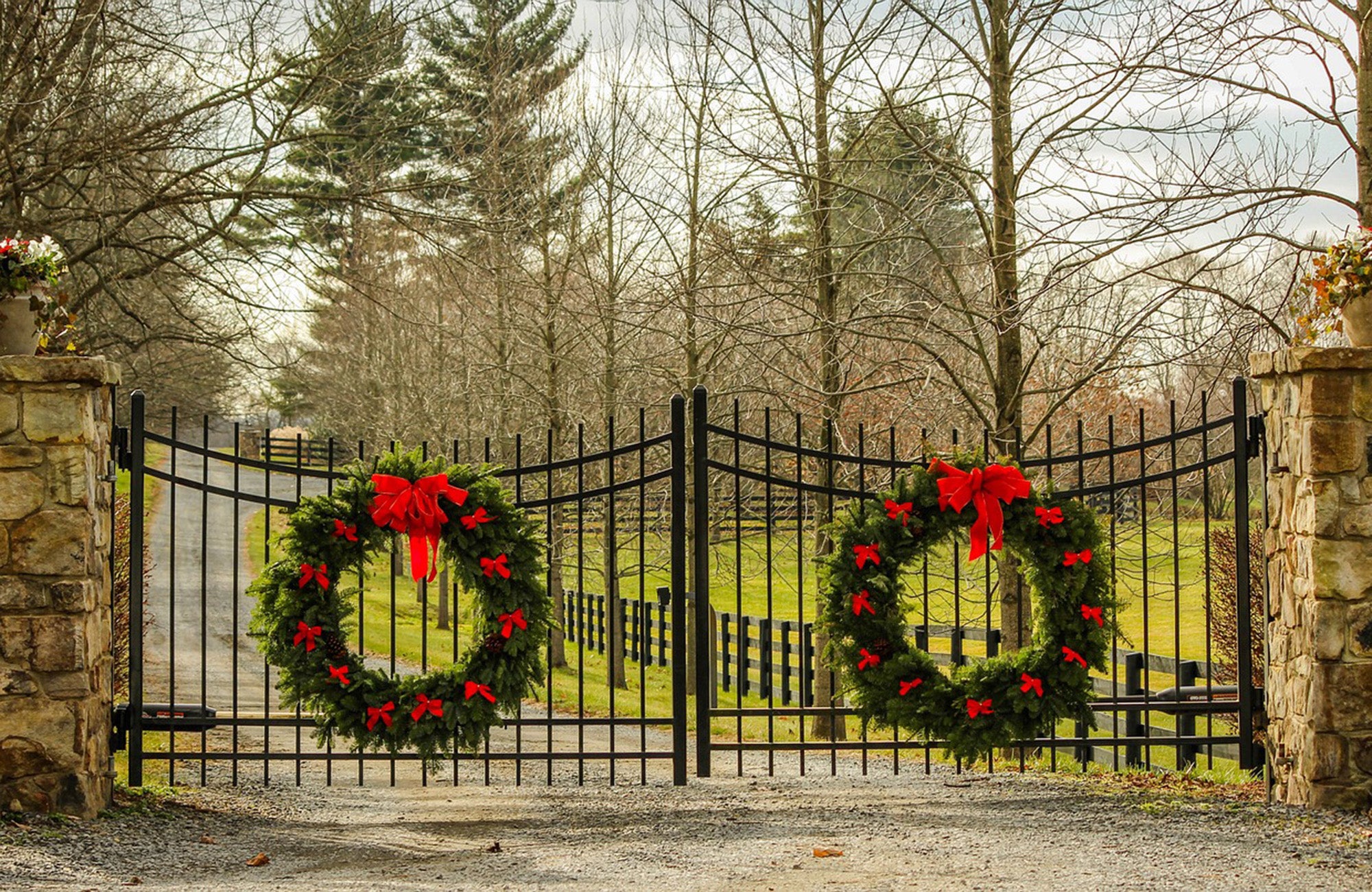 Two Christmas wreaths adorning front gates of luxury property