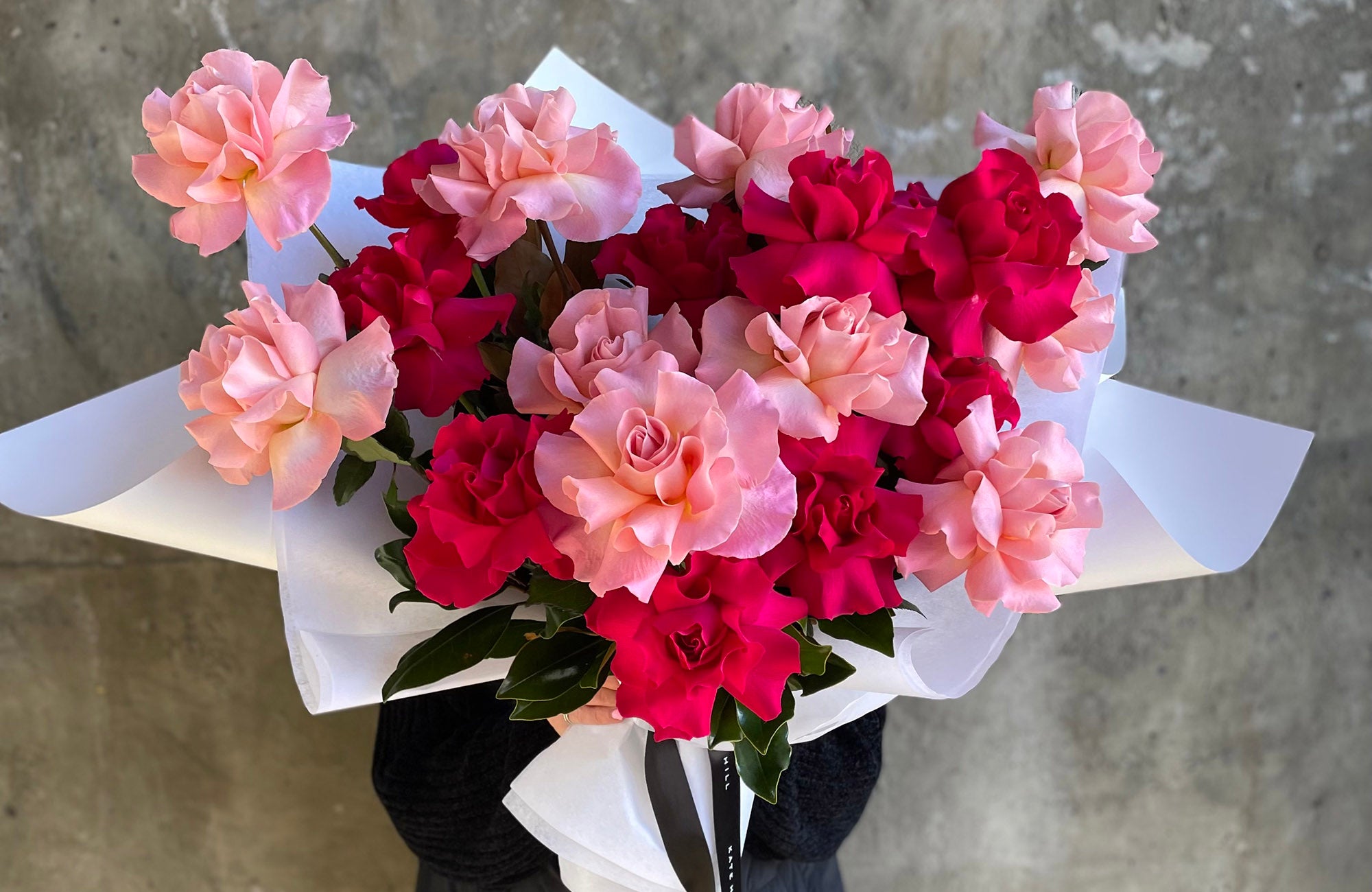 Reflexed rose bouquet in white wrapping paper