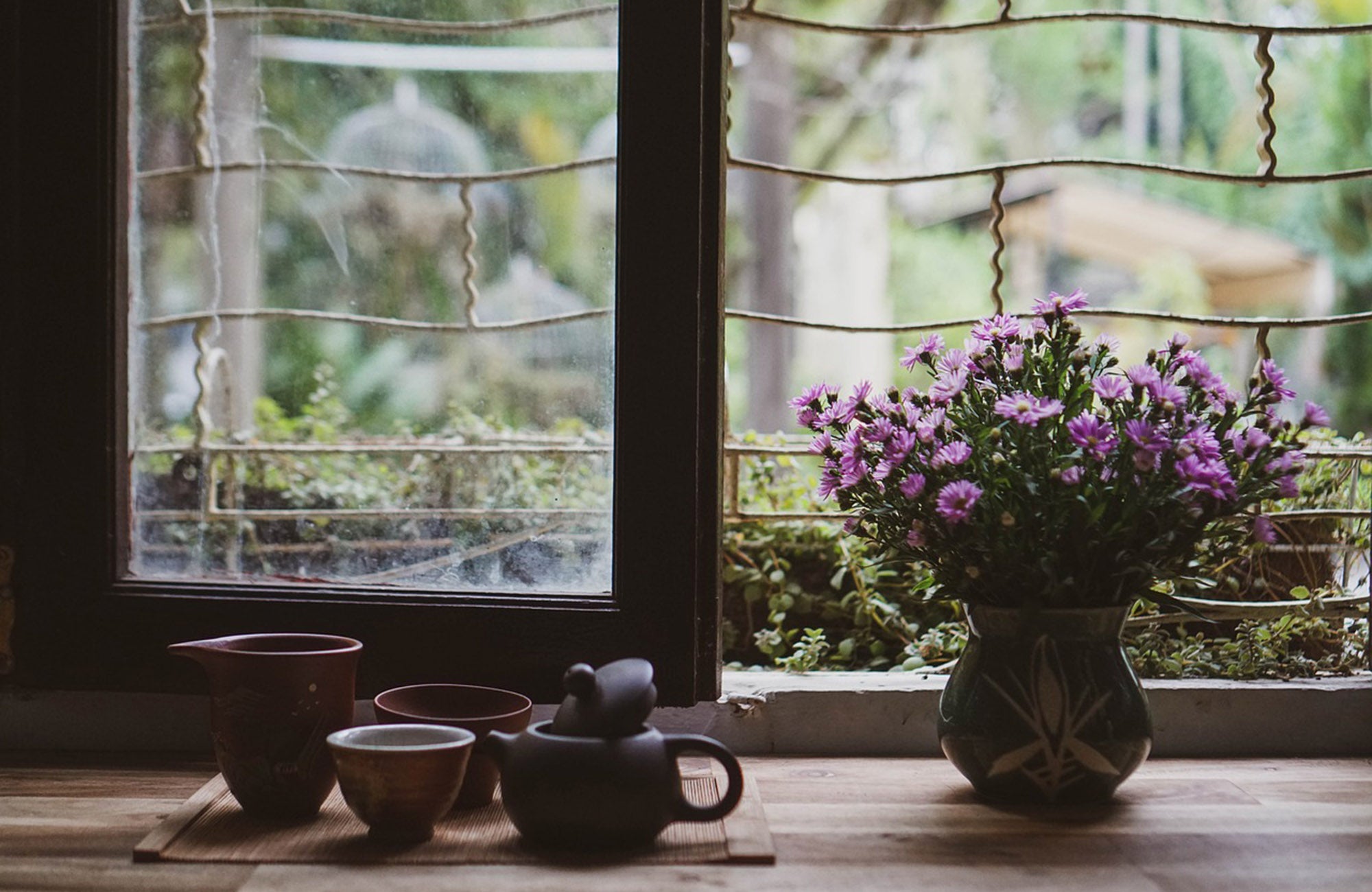 Pink flowers in vase on display on a kitchen bench