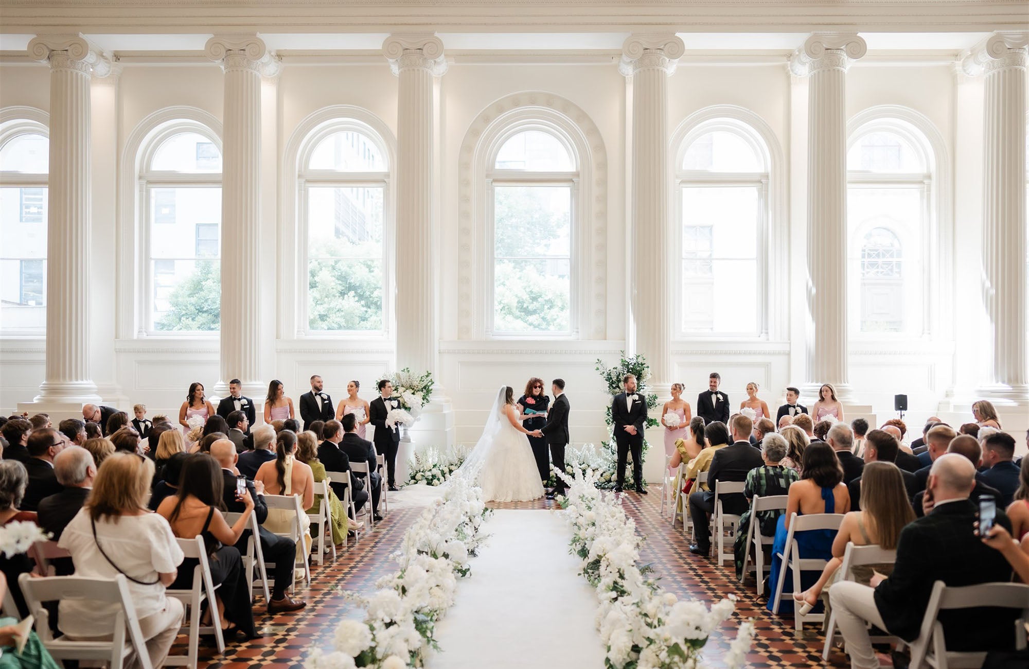 Wedding ceremony filled with white wedding flowers