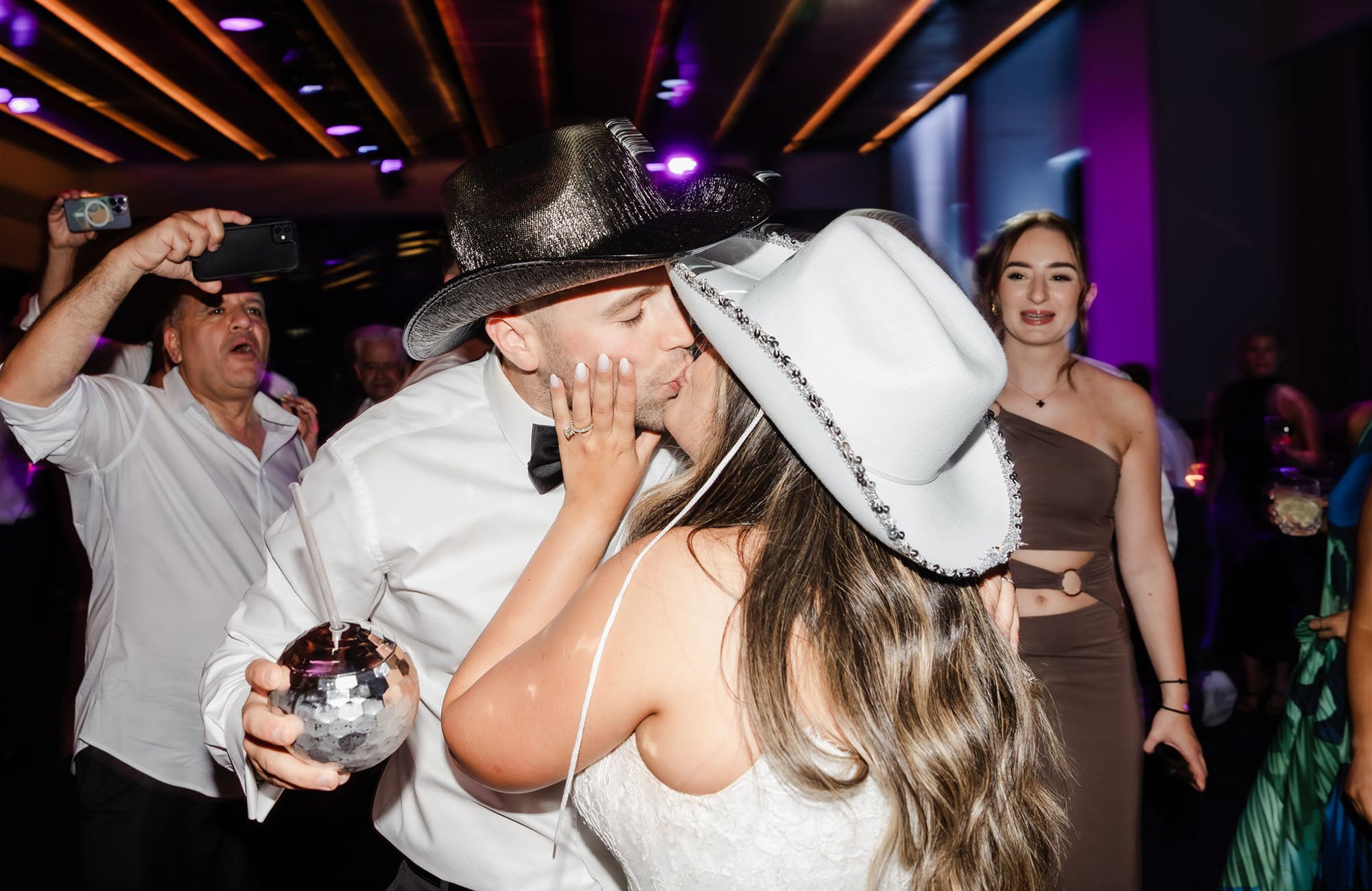Bride and groom kissing at wedding reception party