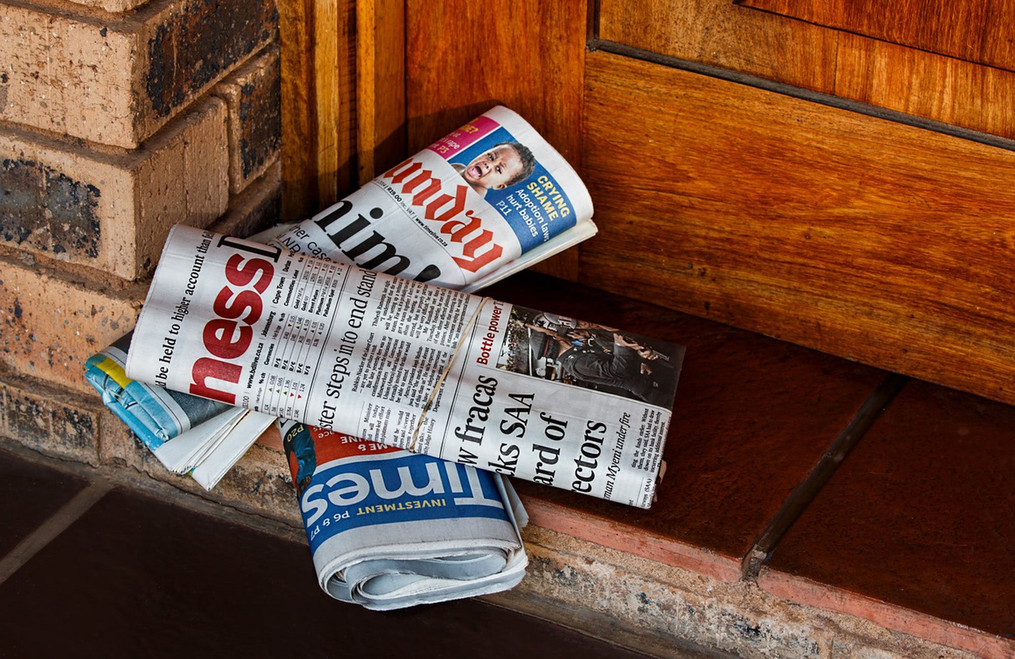 Newspapers left at front door