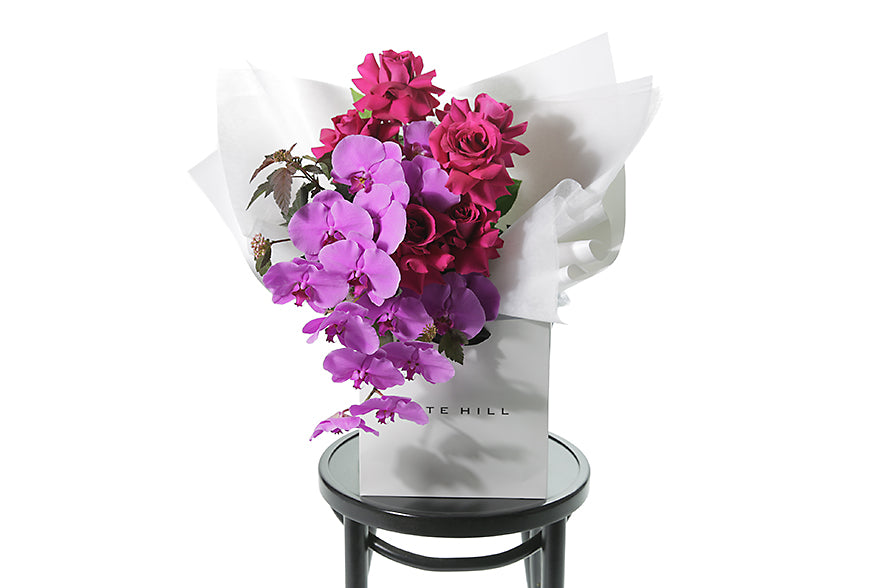 Pink coloured Valentine's Day Bouquet in white bag