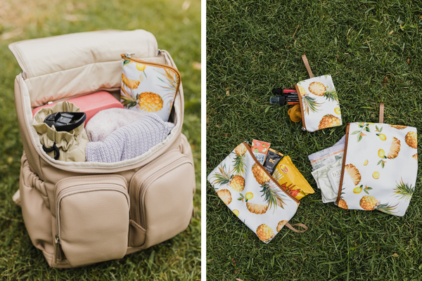 A nappy bag packed with essentials for a day at the beach, including diapers, wipes, and sunscreen