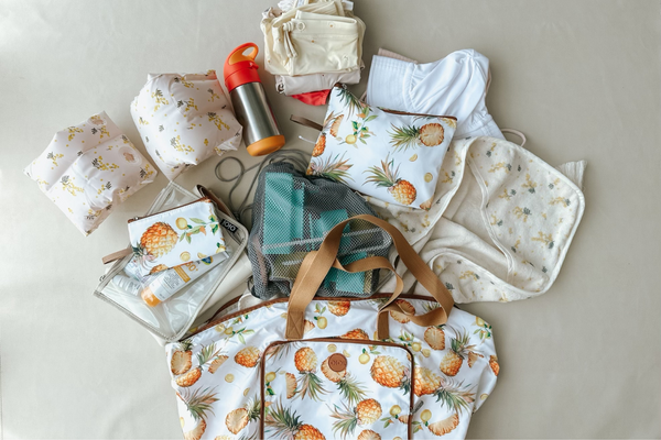 A large beach bag packed full of items such as towels, sunscreen, and water bottles for a family outing