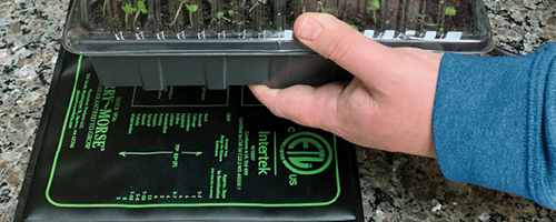 Heat mat under a seed starting tray