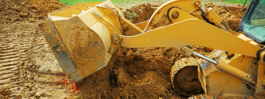 Excavator moving dirt for new home construction