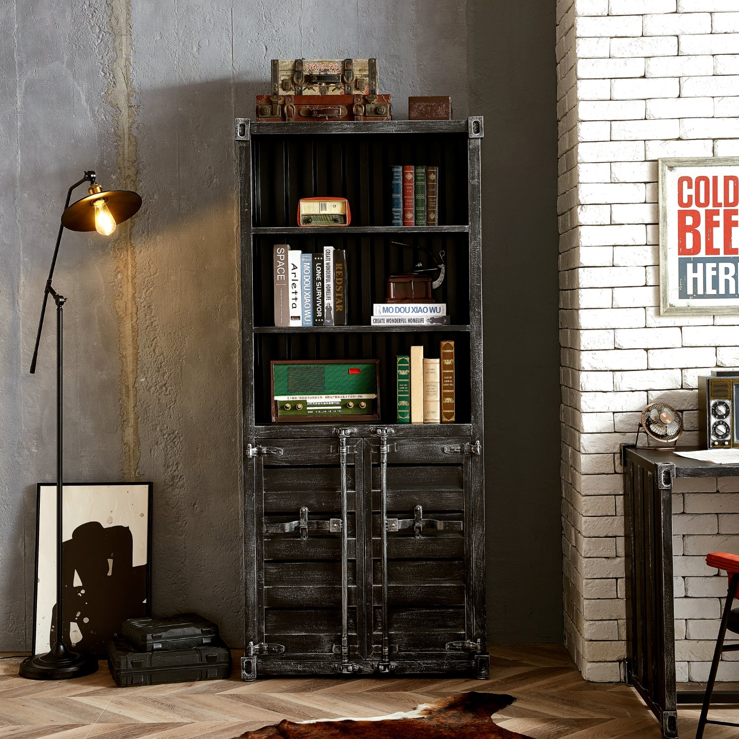 Vintage style industrial shelf with half doors stocked with books and decor. Set in a room with concrete walls and exposed white washed brick.