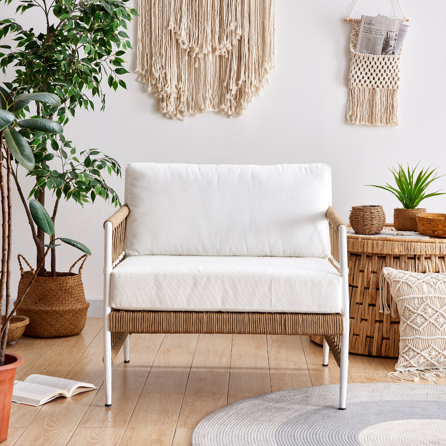 light wicker sofa styled with bolster pillows, soft throw blanket, and macrame decor. Set in an earthy room with natural fiber decor and hardwood floors.