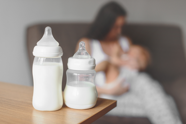 New mum using double electric breast pump and nursing baby 