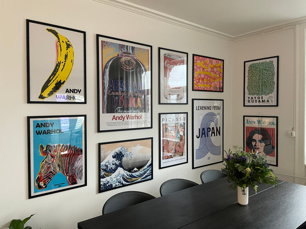 Poster wall with art posters in black wooden frames